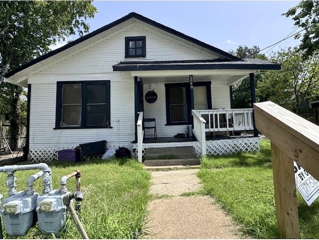 bungalow with a front yard and a porch