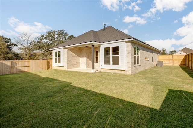 back of property featuring a patio area, a yard, and central AC unit