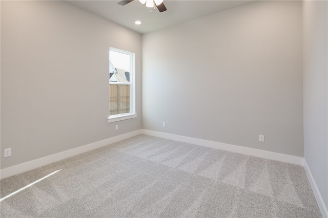 empty room featuring ceiling fan and carpet