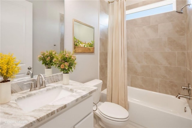 full bathroom featuring shower / tub combo, vanity, and toilet