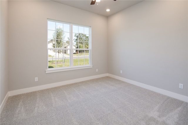 unfurnished room with carpet flooring, a wealth of natural light, and ceiling fan