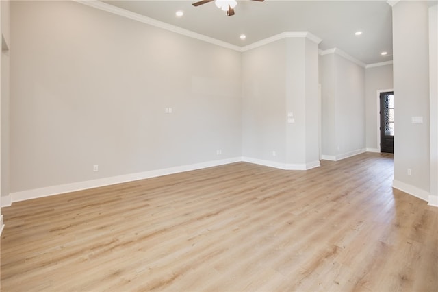 spare room featuring ceiling fan, light wood-type flooring, and ornamental molding