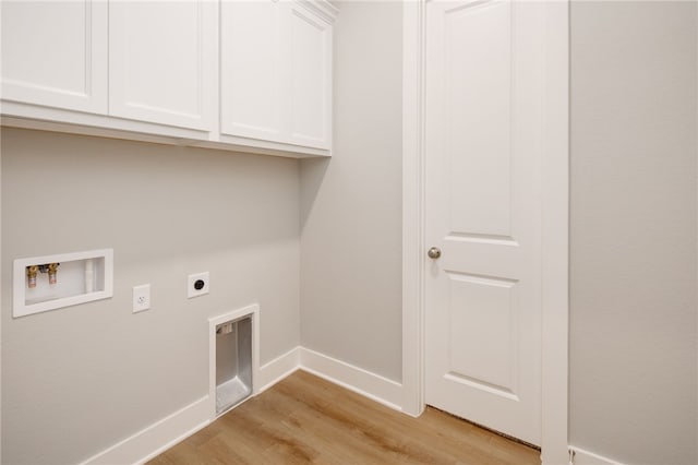 laundry area with cabinets, light hardwood / wood-style flooring, washer hookup, and hookup for an electric dryer