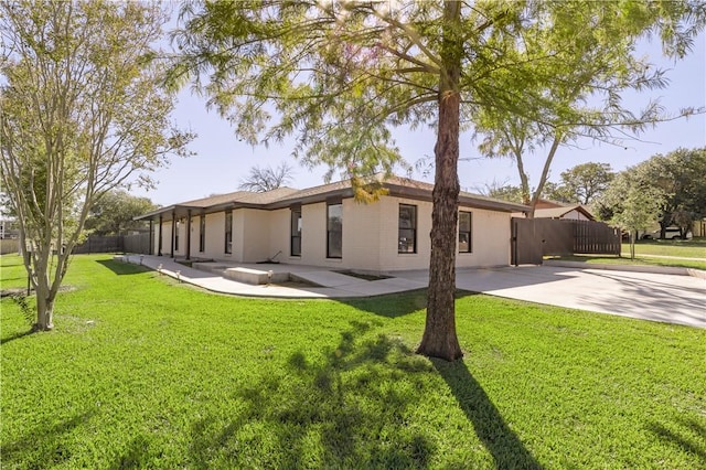 back of property featuring a lawn