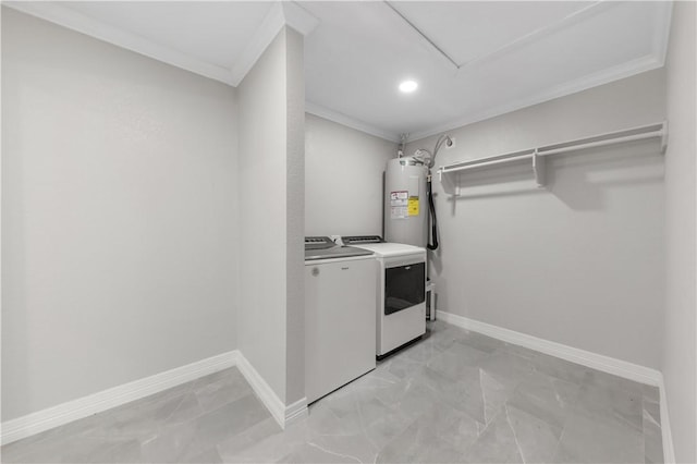 washroom featuring washer and clothes dryer, ornamental molding, and water heater