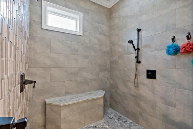 bathroom featuring crown molding and tiled shower