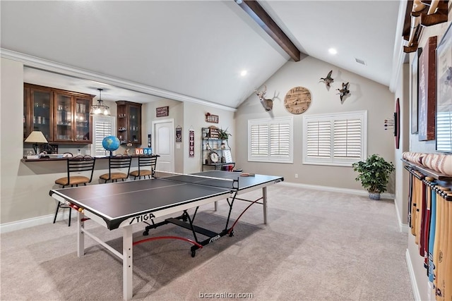 recreation room with vaulted ceiling with beams, light colored carpet, a healthy amount of sunlight, and indoor bar