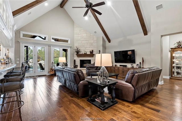 living room featuring ceiling fan, dark hardwood / wood-style flooring, high vaulted ceiling, beamed ceiling, and a fireplace