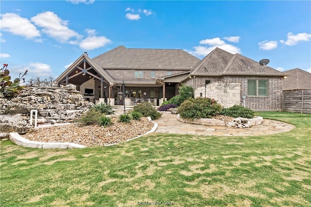 rear view of property featuring a yard and a patio