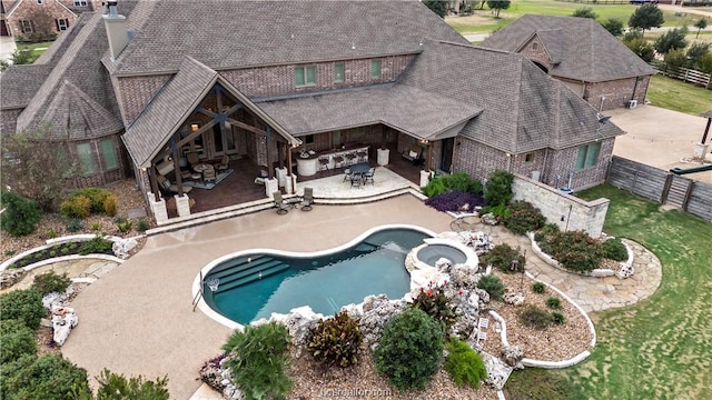 view of pool featuring an outdoor kitchen and a patio area