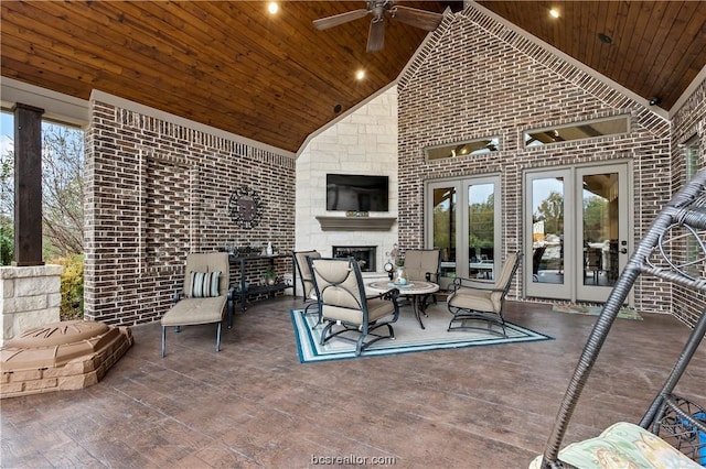 view of patio / terrace with ceiling fan, an outdoor fireplace, and french doors