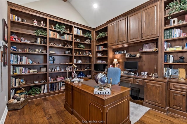 office with built in desk, dark hardwood / wood-style floors, and vaulted ceiling