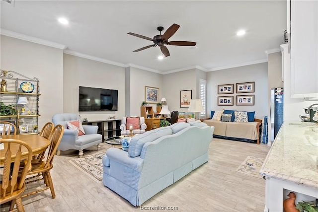 living room featuring light hardwood / wood-style flooring, ceiling fan, crown molding, and sink