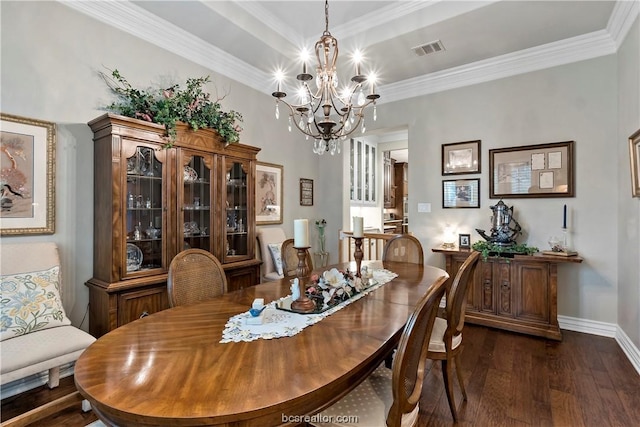 dining space featuring crown molding, dark wood-type flooring, and an inviting chandelier