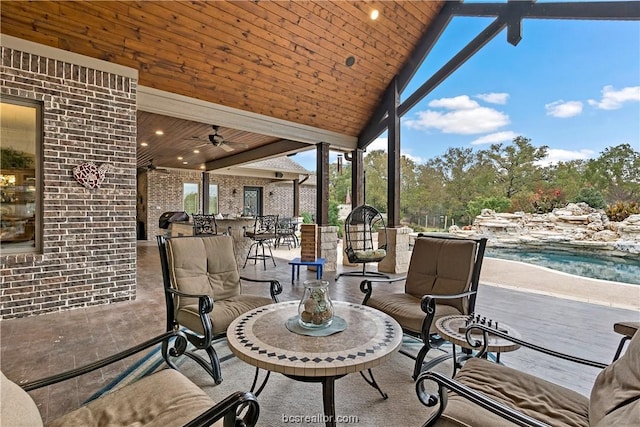 view of patio with ceiling fan and an outdoor bar