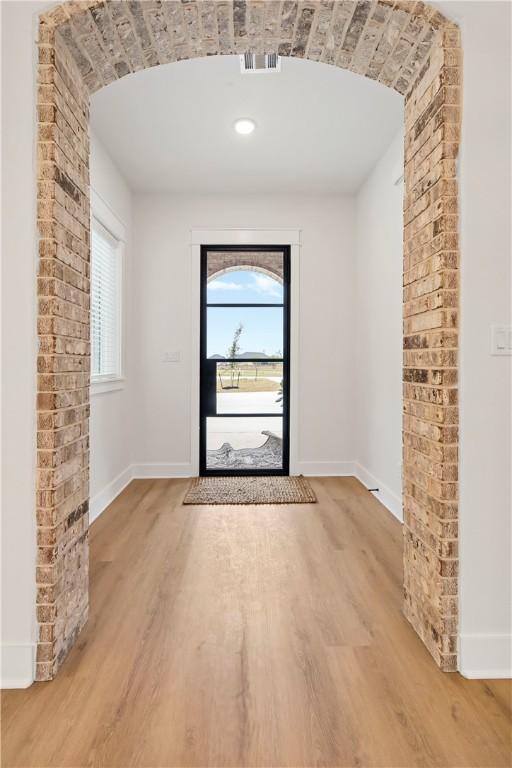 doorway with wood-type flooring