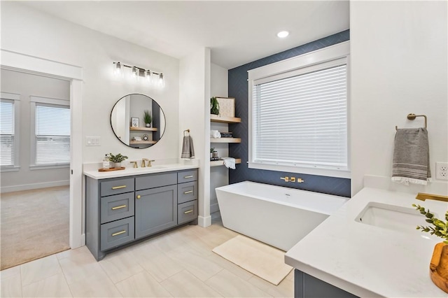 bathroom featuring vanity and a bath