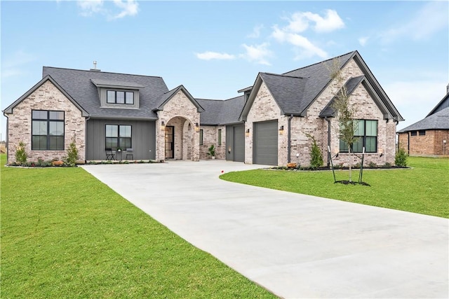 french country home with a garage and a front lawn