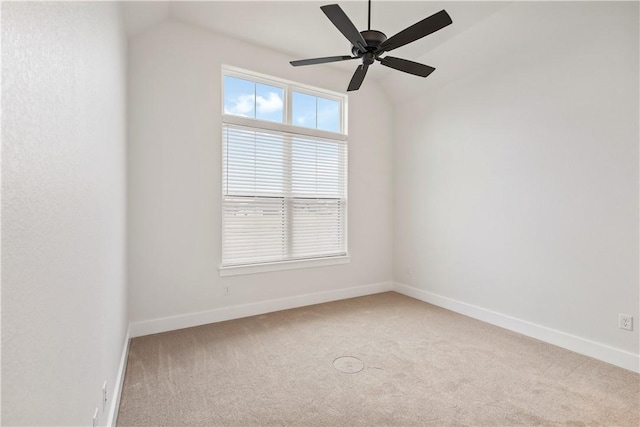 spare room with ceiling fan, light colored carpet, and lofted ceiling