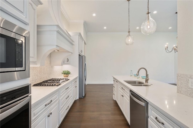 kitchen with tasteful backsplash, white cabinets, a sink, light countertops, and stainless steel appliances