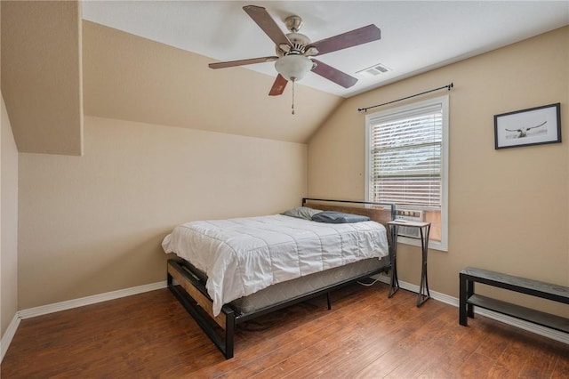 bedroom featuring vaulted ceiling, dark hardwood / wood-style floors, and ceiling fan