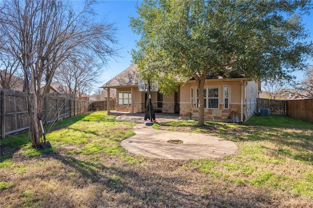 rear view of house with a yard, a patio area, and central air condition unit