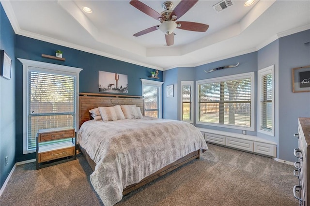 carpeted bedroom with ceiling fan, ornamental molding, and a tray ceiling