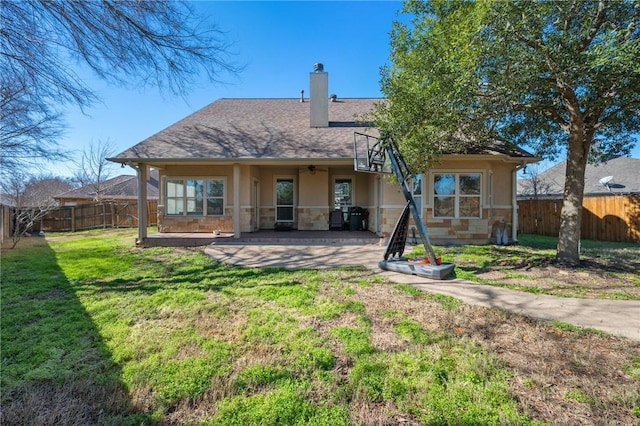 rear view of property featuring a patio area and a lawn