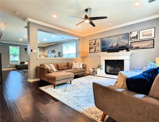 14504 Templemore Cv, Austin, TX 78717 - living room featuring dark wood-style flooring, ornamental molding, ceiling fan, and a fireplace with raised hearth