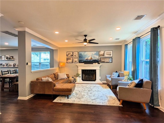 14504 Templemore Cv, Austin, TX 78717 - living room with a ceiling fan, ornamental molding, visible vents, and a fireplace with raised hearth