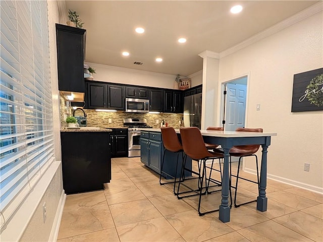 14504 Templemore Cv, Austin, TX 78717 - kitchen featuring crown molding, dark cabinetry, backsplash, and appliances with stainless steel finishes