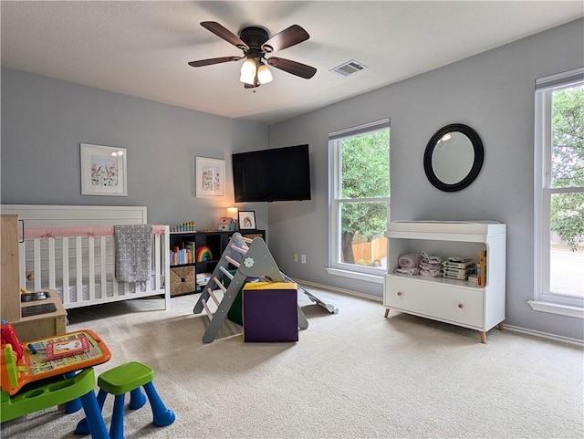 14504 Templemore Cv, Austin, TX 78717 - carpeted bedroom featuring a crib, baseboards, visible vents, and multiple windows