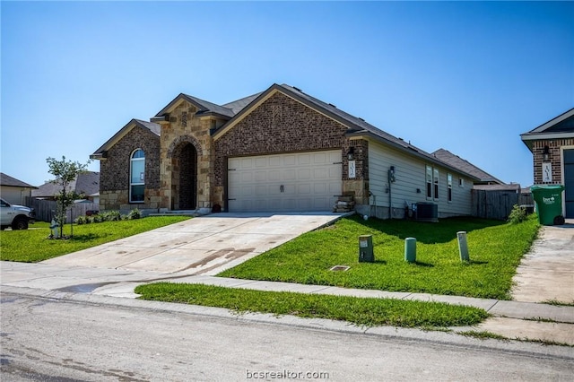 view of front of house featuring cooling unit, a front lawn, and a garage