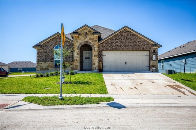 view of property featuring a garage, central air condition unit, and a front lawn