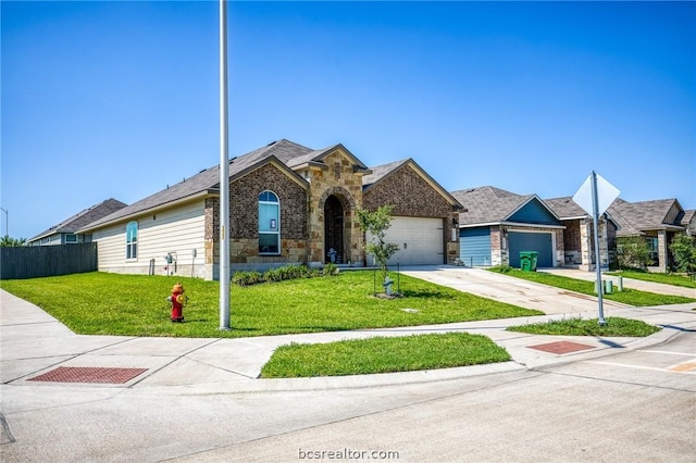 view of front of house featuring a garage and a front yard