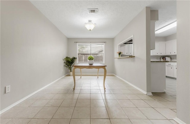 2904 Adrienne Dr, College Station, TX 77845 - dining space featuring light tile patterned flooring and a textured ceiling