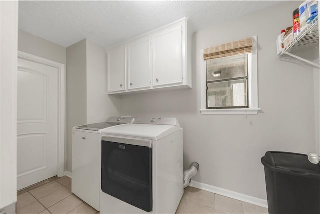 2904 Adrienne Dr, College Station, TX 77845 - laundry area featuring independent washer and dryer, cabinet space, light tile patterned flooring, and a textured ceiling