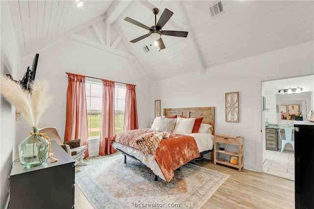 bedroom with high vaulted ceiling, ensuite bath, ceiling fan, beamed ceiling, and light hardwood / wood-style floors