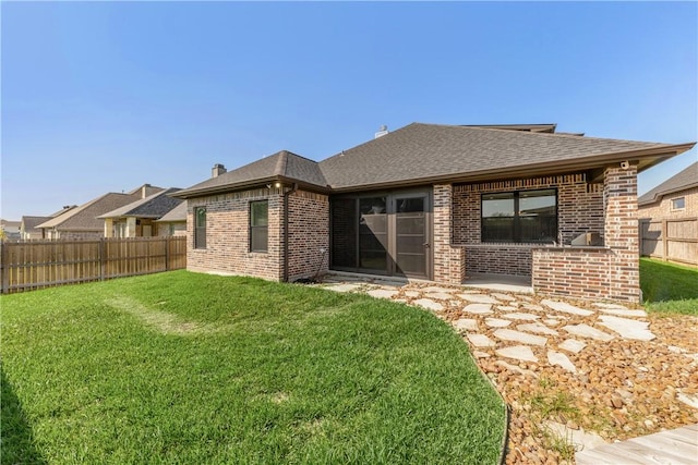 rear view of property featuring a yard