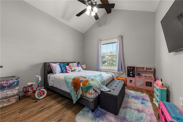 bedroom featuring dark wood-type flooring, vaulted ceiling with beams, and ceiling fan