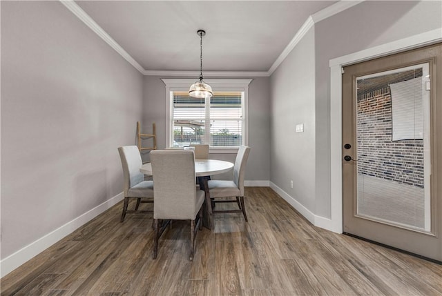 dining room with crown molding and hardwood / wood-style floors