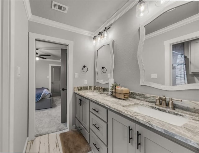 bathroom featuring vanity, ornamental molding, and ceiling fan