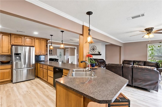 kitchen with pendant lighting, black dishwasher, sink, stainless steel fridge, and ornamental molding