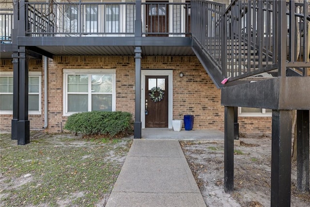 view of exterior entry with brick siding