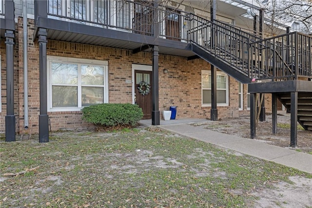 property entrance featuring brick siding