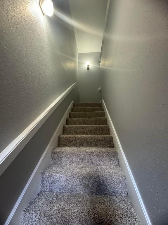 staircase featuring vaulted ceiling