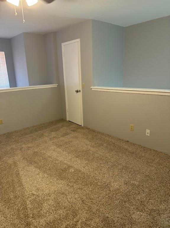 unfurnished room with ceiling fan and carpet floors