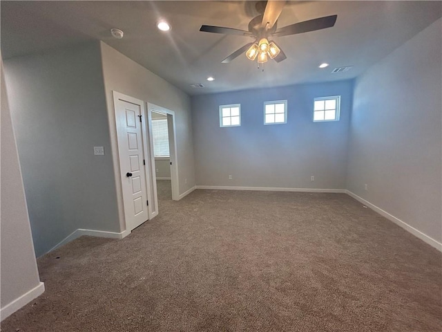 unfurnished room with carpet floors, recessed lighting, visible vents, and baseboards