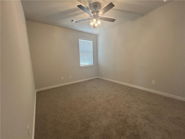 unfurnished room featuring dark colored carpet, visible vents, ceiling fan, and baseboards