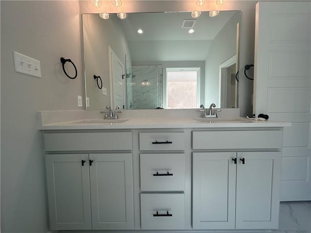 full bathroom featuring marble finish floor, a sink, a shower stall, and double vanity